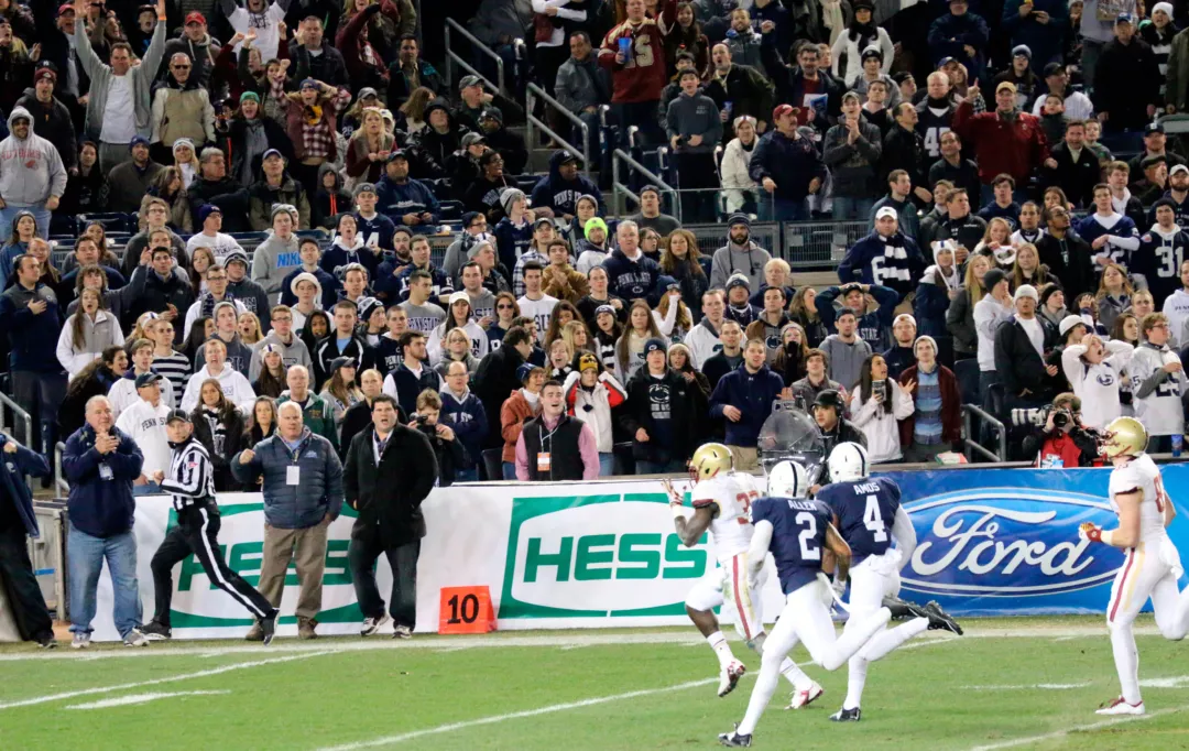 A-frame sideline signature banner displays with sponsorship banners on the sidelines.