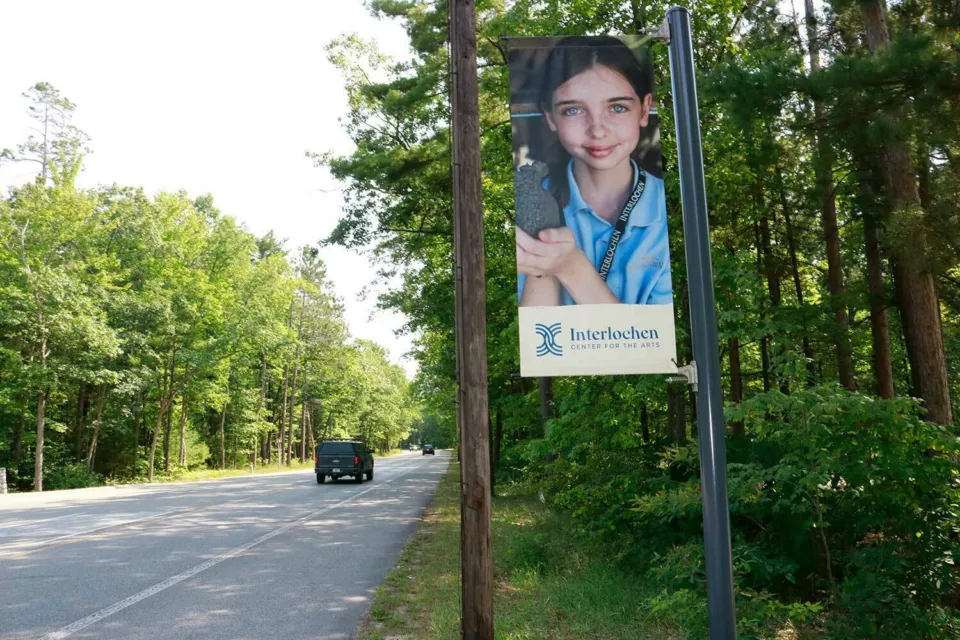 A light pole banner for Interlochen Arts Academy with a student on it